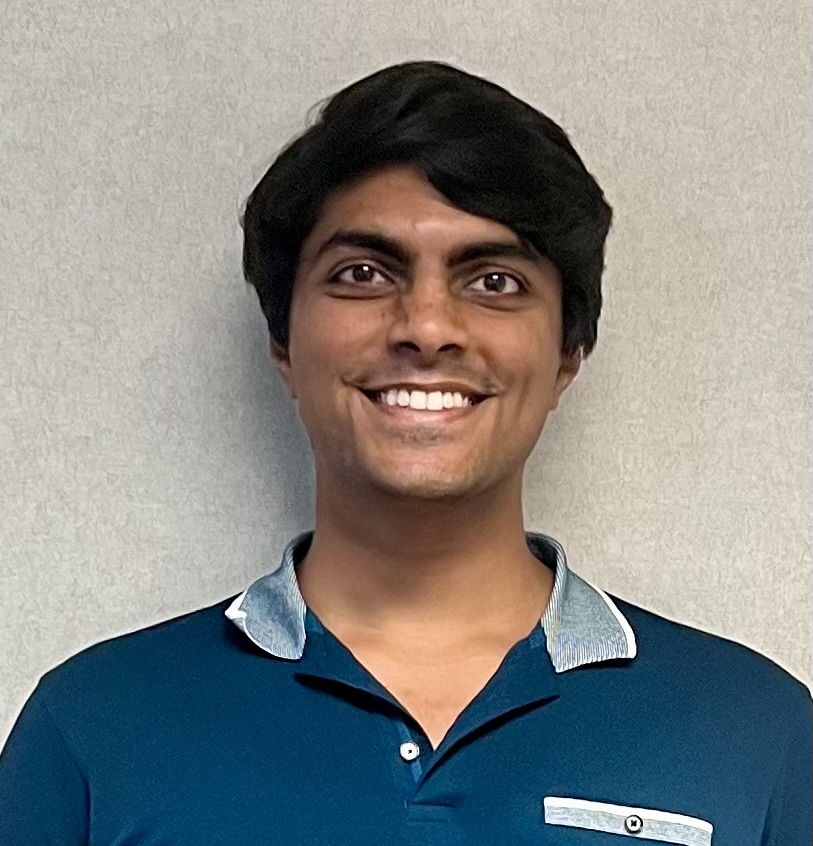 Professional man smiling confidently, embodying Mined XAI's human-in-the-loop explainable AI expertise.