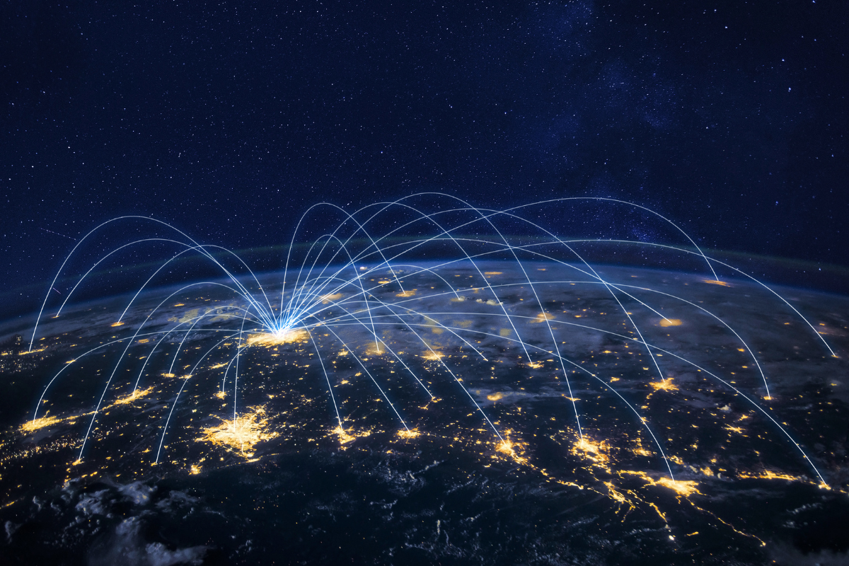 Earth from space at night with glowing lines connecting city lights, symbolizing a global AI-powered logistics and supply cha